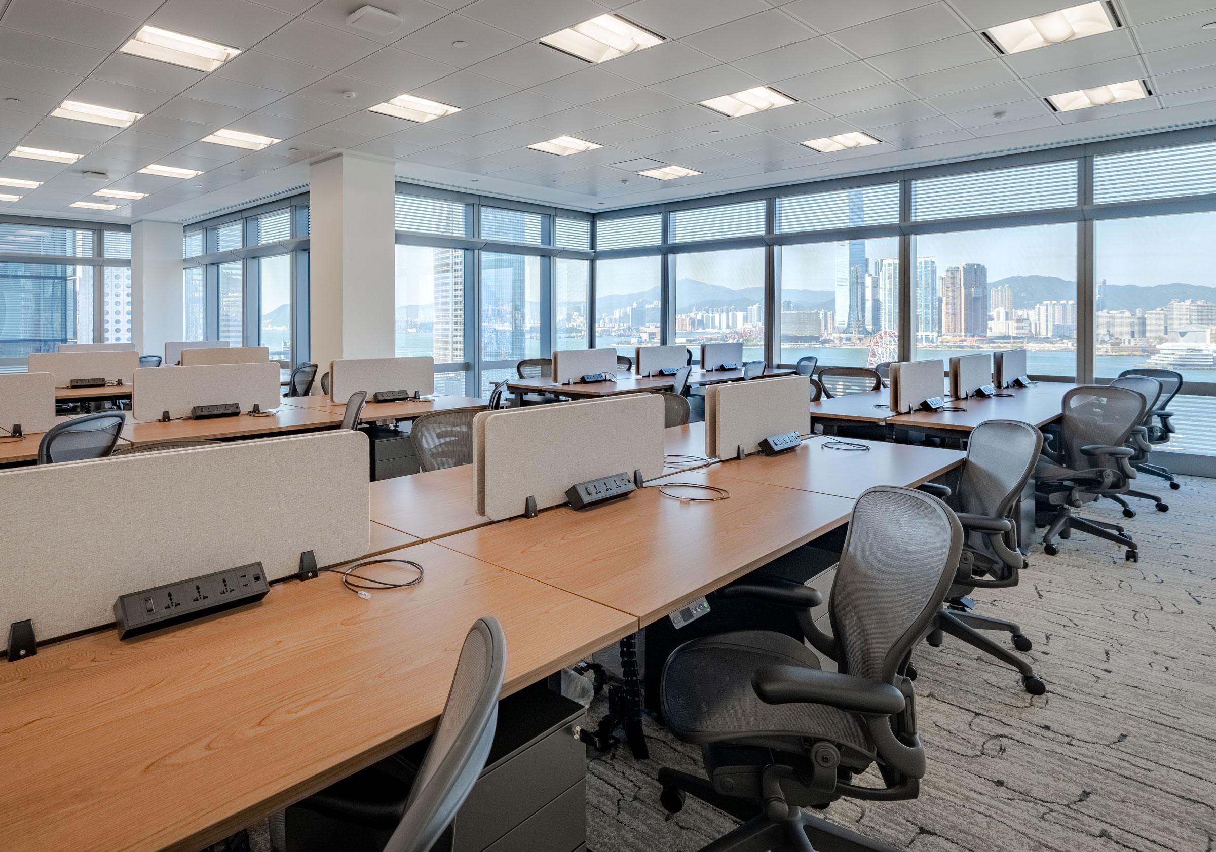 Modern private office suite with workspace seating and city views